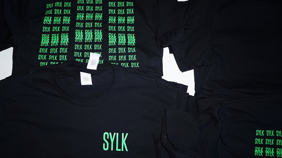Black t-shirt with neon green 'SYLK' logo in top right corner on the front and multiple overlapping neon green 'SYLK' logos c