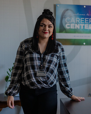 A female career center specialist smiling at her desk