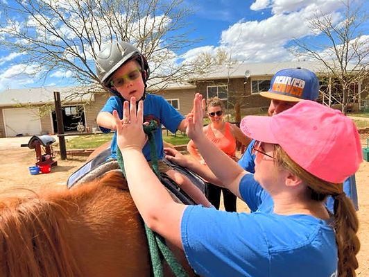 Disabled rider on horse with volunteer