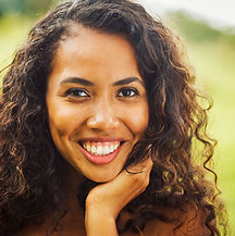 A woman with a happy white smile after a veneer appointment