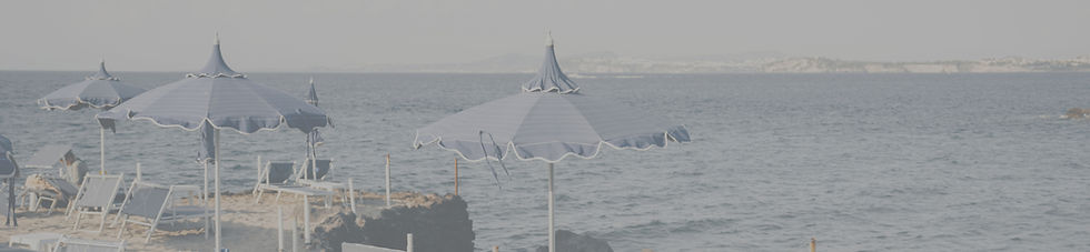 Sandy beach with blue umbrellas, lounge