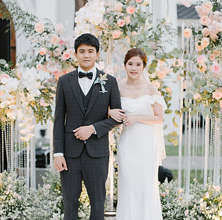 Elegant pink and white floral wedding arch for ceremony stage
