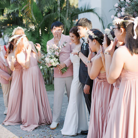Bridesmaids wearing blush dresses celebrating together outdoors