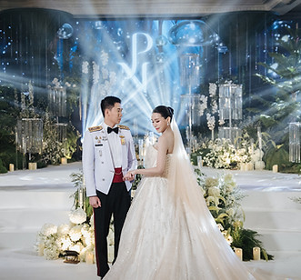 Romantic hotel ballroom wedding with elegant floral arch and crystal chandeliers