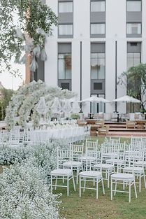An ethereal outdoor wedding celebration characterized by a pristine all-white aesthetic. Set within a manicured garden, the event features sprawling white floral installations, elegant long-table dining, and a romantic winding aisle that creates a dreamlike atmosphere for a timeless union.

Designed and curated by VIRADA Creative Wedding Planner, specializing in luxury destination weddings in Northern Thailand.