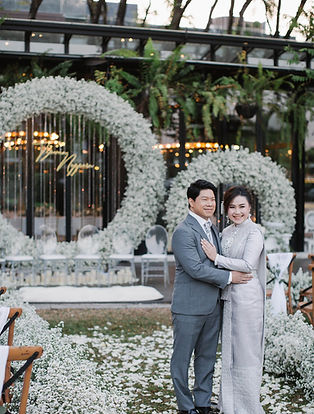 Wedding stage decorated with giant circular floral arch made of white baby’s breath.