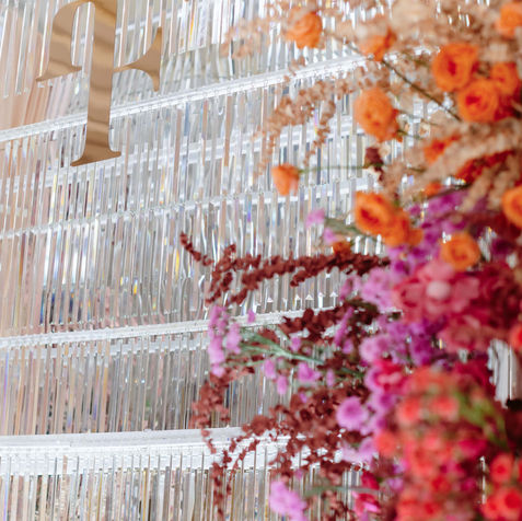 Close-up of magenta-colored flowers intertwined with silver metallic streamers.