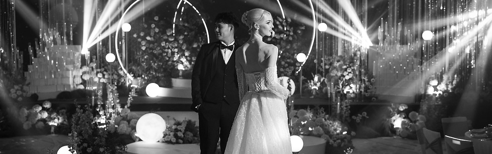 Bride and groom walking hand in hand on a wedding stage with LED backdrop