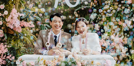 Bride and groom entering the traditional Thai water pouring ceremony