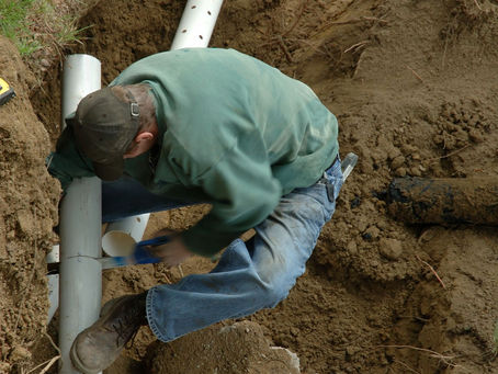 man fixing drain field in Jacksonville