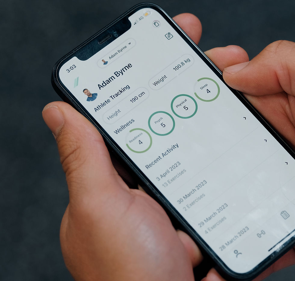 A picture of someone holding a phone in their hands. On the phone the Output Sports app is shown, on an athlete tracking page with wellness scores entered and the numbers shown.