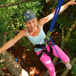 Older lady tree climbing with Treetop Rocks CIC