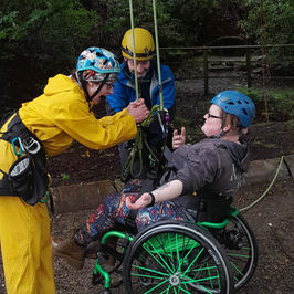 lady in wheelchair tree climbing with Treetop Rocks CIC
