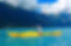 Woman kayaking in a yellow boat on turquoise waters