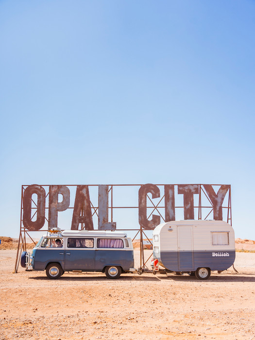 Tourism photography in regional Australia, Kombi van in front of Opal City Sign in Cooper Peedy