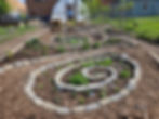 Medicinal and Culinary herb spirals with native plants in the center.