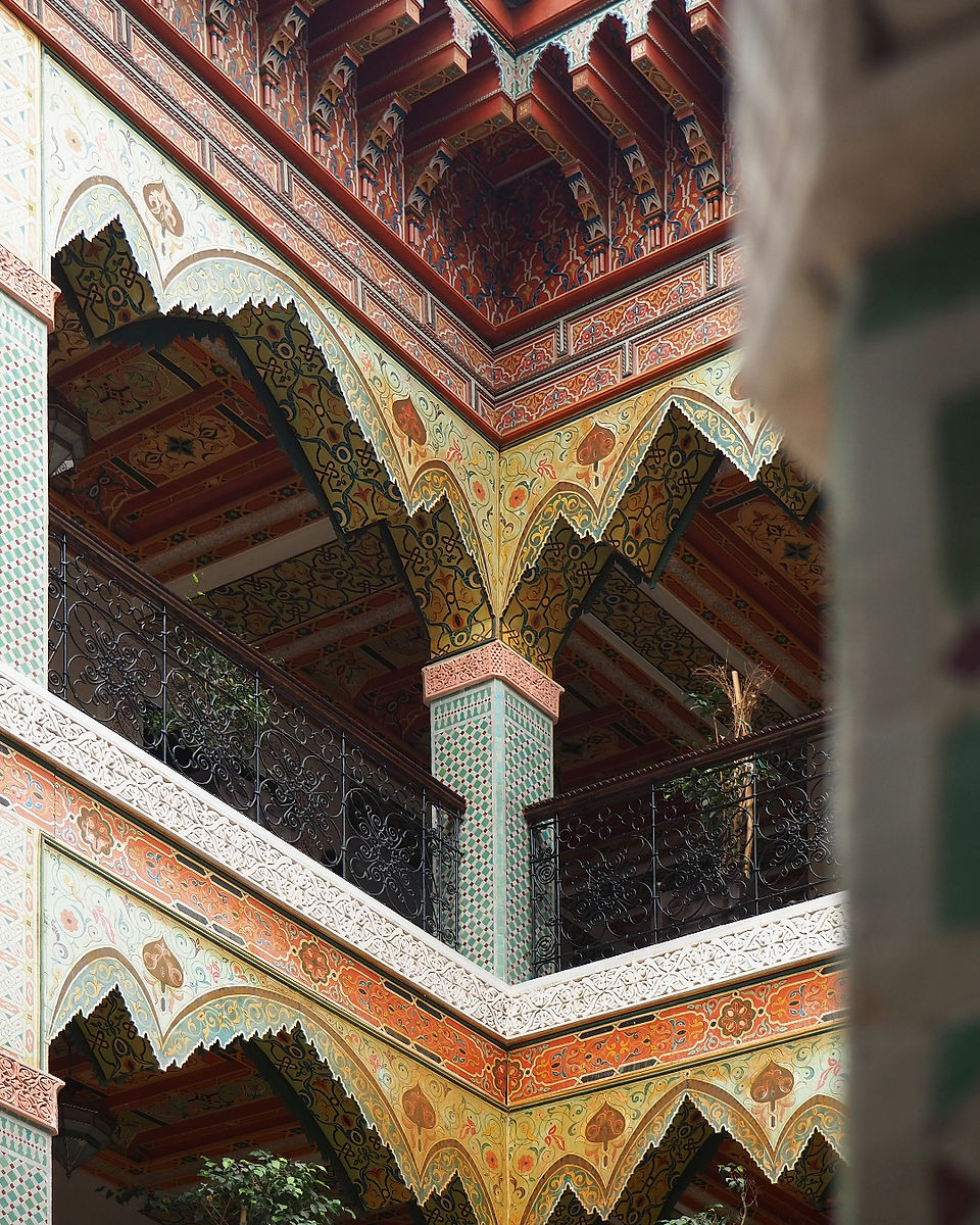Intricate wooden and painted plaster details in a traditional Moroccan riad — architectural craftsmanship observed during our Moroccan architecture journey in Fez.