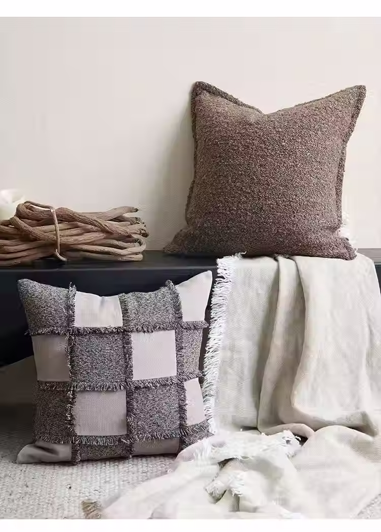 Eye-level view of a pile of colorful scatter cushions on a sofa