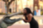 Student posing next to a gator statue