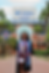 Graduate standing in front of university stadium