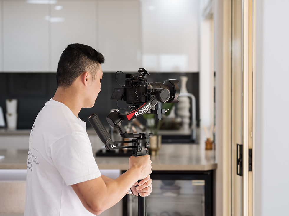 Michael holding a gimbal while filming on-site – behind-the-scenes property videography by Motif Studio in Brisbane