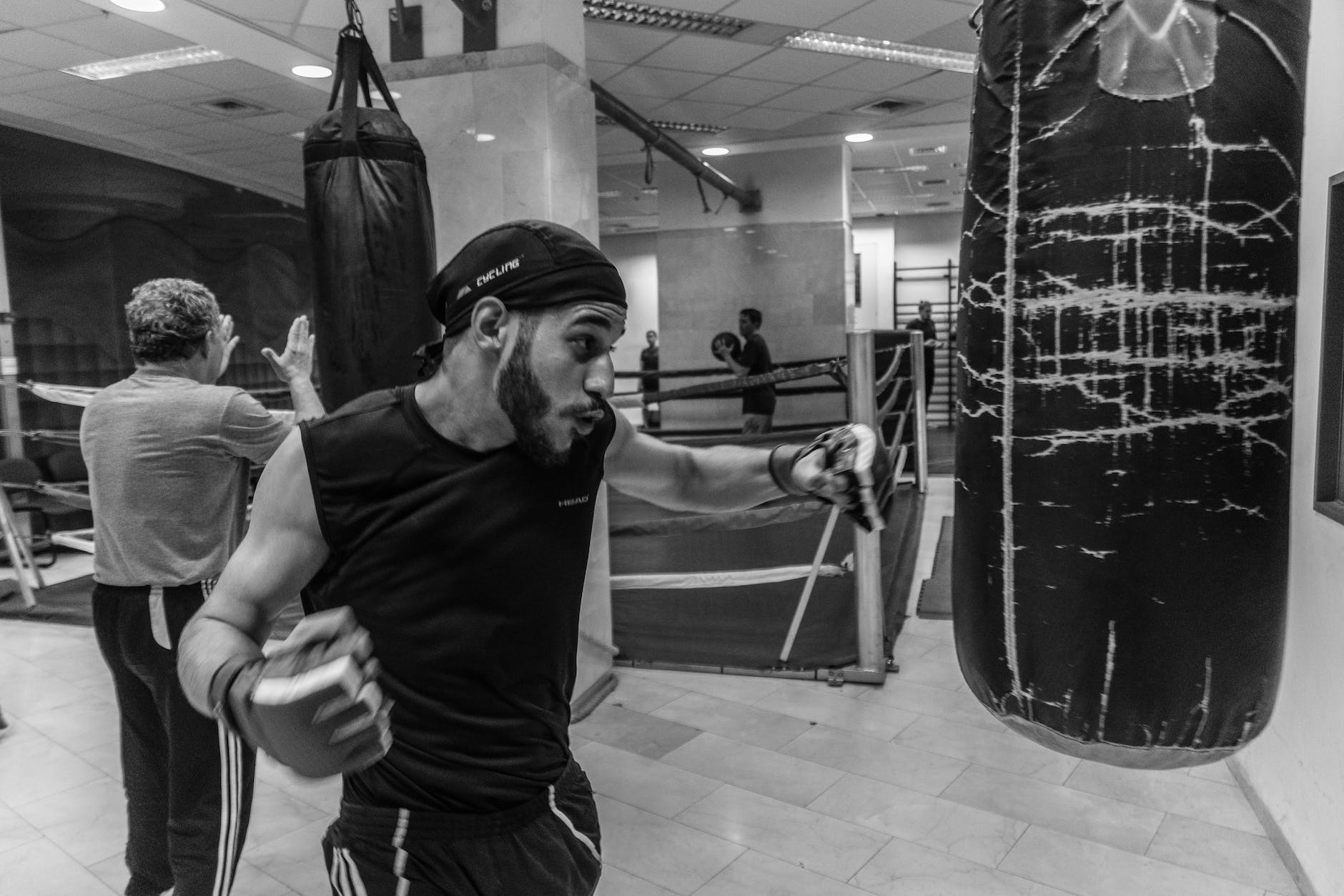 person beside black leather heavy bag