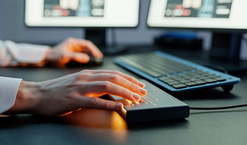 Hands using an assistive tech keyboard in an office