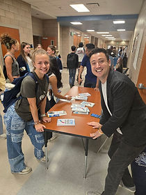 Kyle Willkom has spread the message of Action Packed Leadership far and wide. Here he is posing with a student leader at an event.