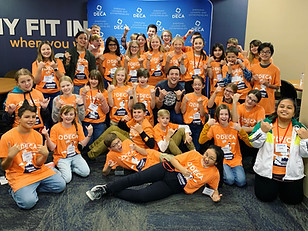 Kyle Willkom posing with participants of a middle school DECA leadership program. Kyle is a top-rated youth motivational speaker.