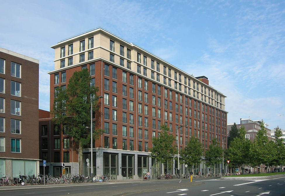 Modern bakstenen appartementsgebouw aan een stadsstraat.