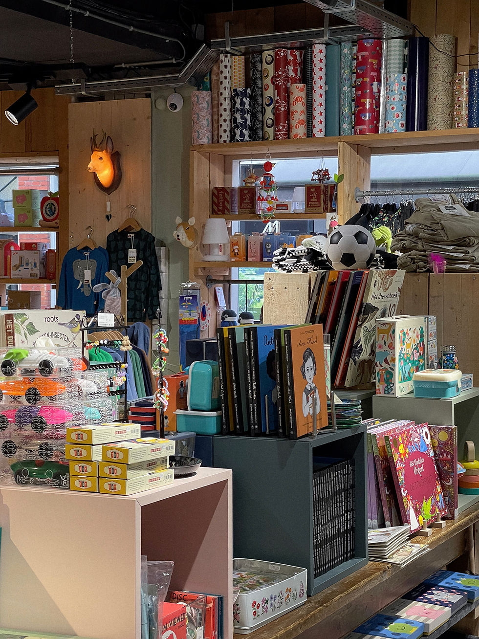 Winkelinterieur met planken vol boeken en cadeaus