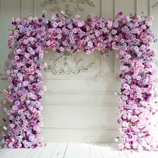 A captivating purple flower arch, adorned with an array of lush blooms, creating a dreamy and enchanting ambiance for your event.