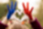 Love and happiness concept. Cute child forming heart gesture with hands outdoors on nature