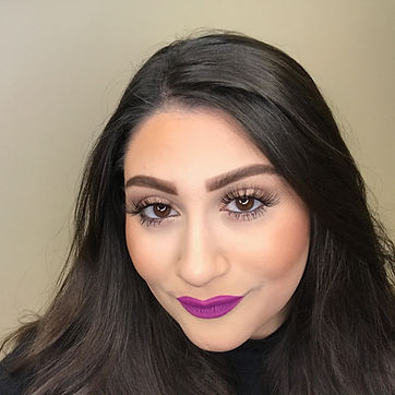 Jennife Weisman Heahsot, She has dark hair, tan skin, and bright purple lipstick.