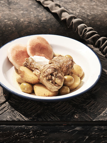 Chicken drumsticks with potatoes and olives served outdoors by Gravel & Salt.