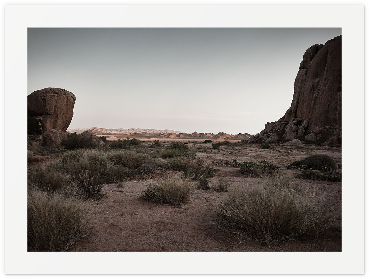 Tierhoek Fine Art Print showing South African desert landscape framed by rugged rocks and dry grass.