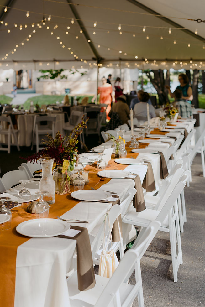 A tented backyard wedding with orange and brown details