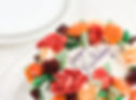 A cake with flower decorations and Happy Birthday written on it