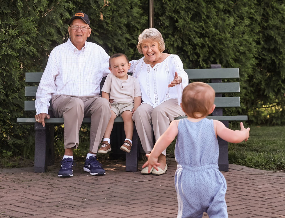 grandparents sitting on bench while kids run to them