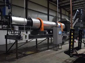A rotary drum dryer manufactured by Midwest Custom Engineering