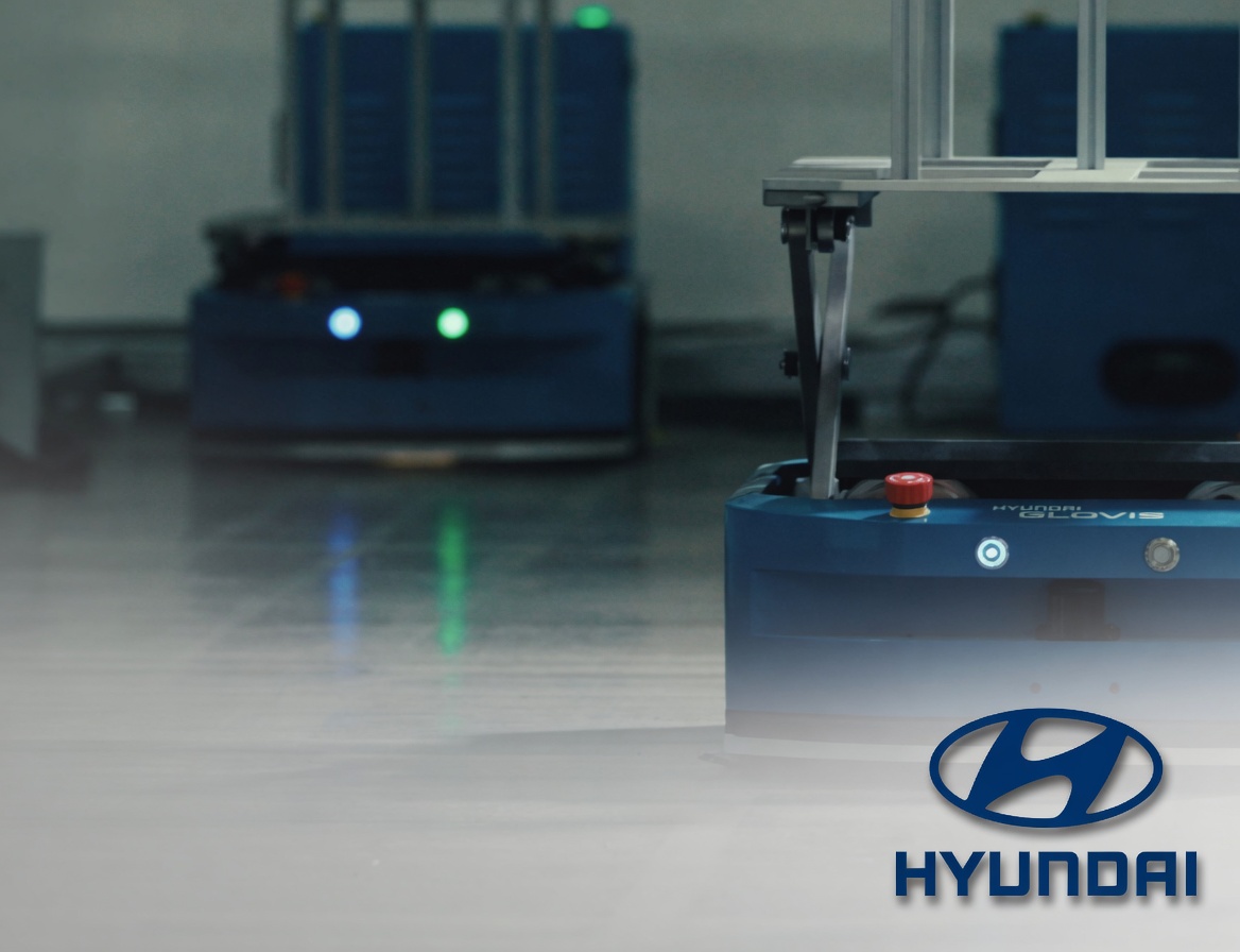 Blue Hyundai Glovis RT-30 AGV robots operate in an automated warehouse. Credit: Capow