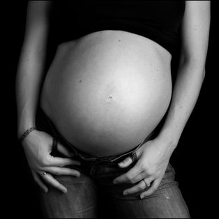 Black and white pregnancy portrait of woman's belly in the Denver, Castle Rock, Highlands
