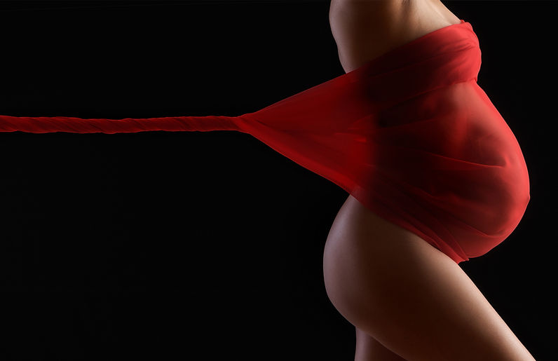 Studio maternity portrait with draping material in the Denver, Boulder, Parker area.
