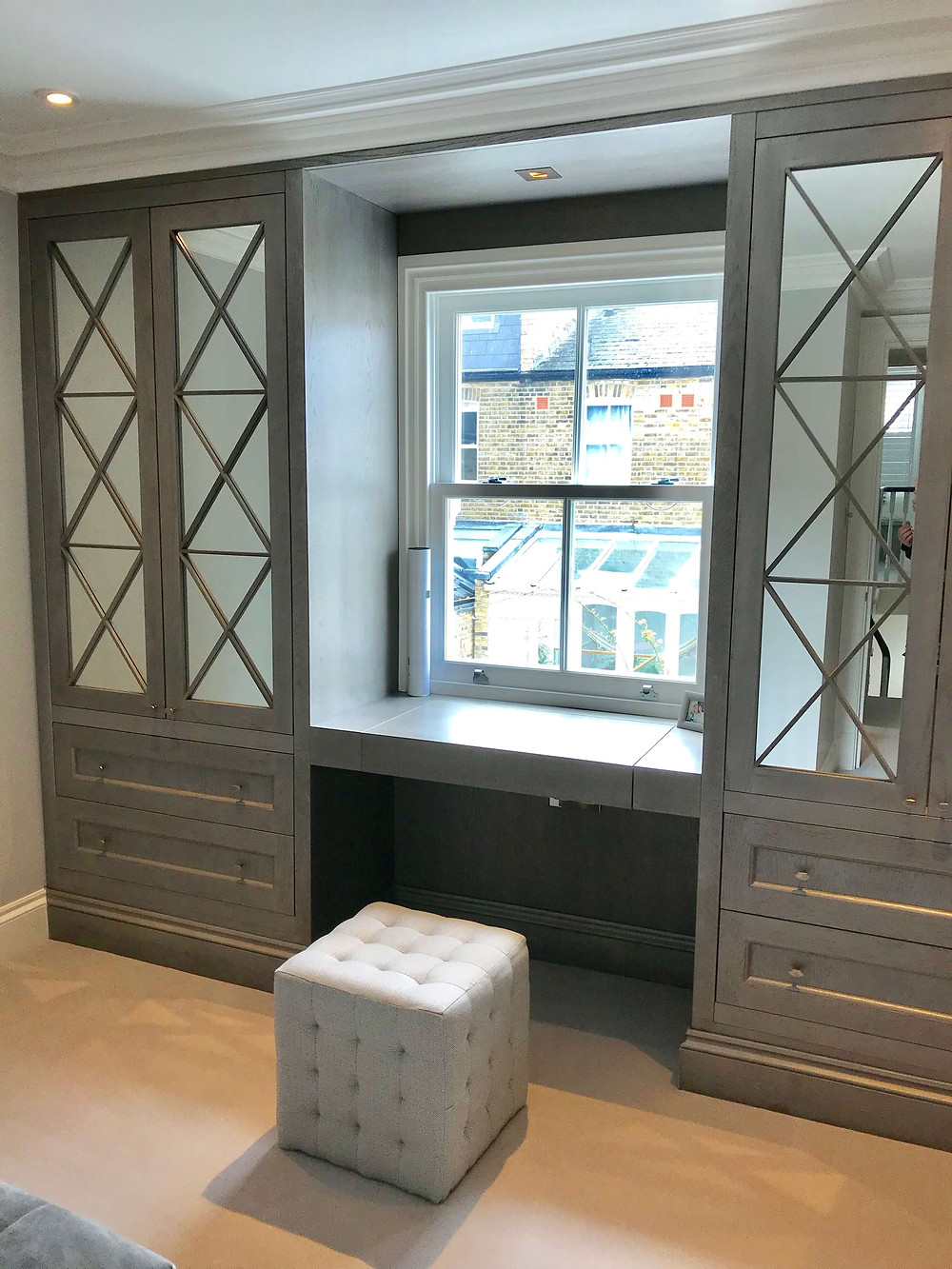 A dressing table with flip-up mirror was made as part of the fitted wardrobes in this small bedroom