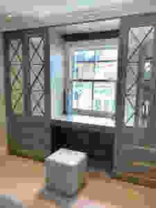 A dressing table with flip-up mirror was made as part of the fitted wardrobes in this small bedroom