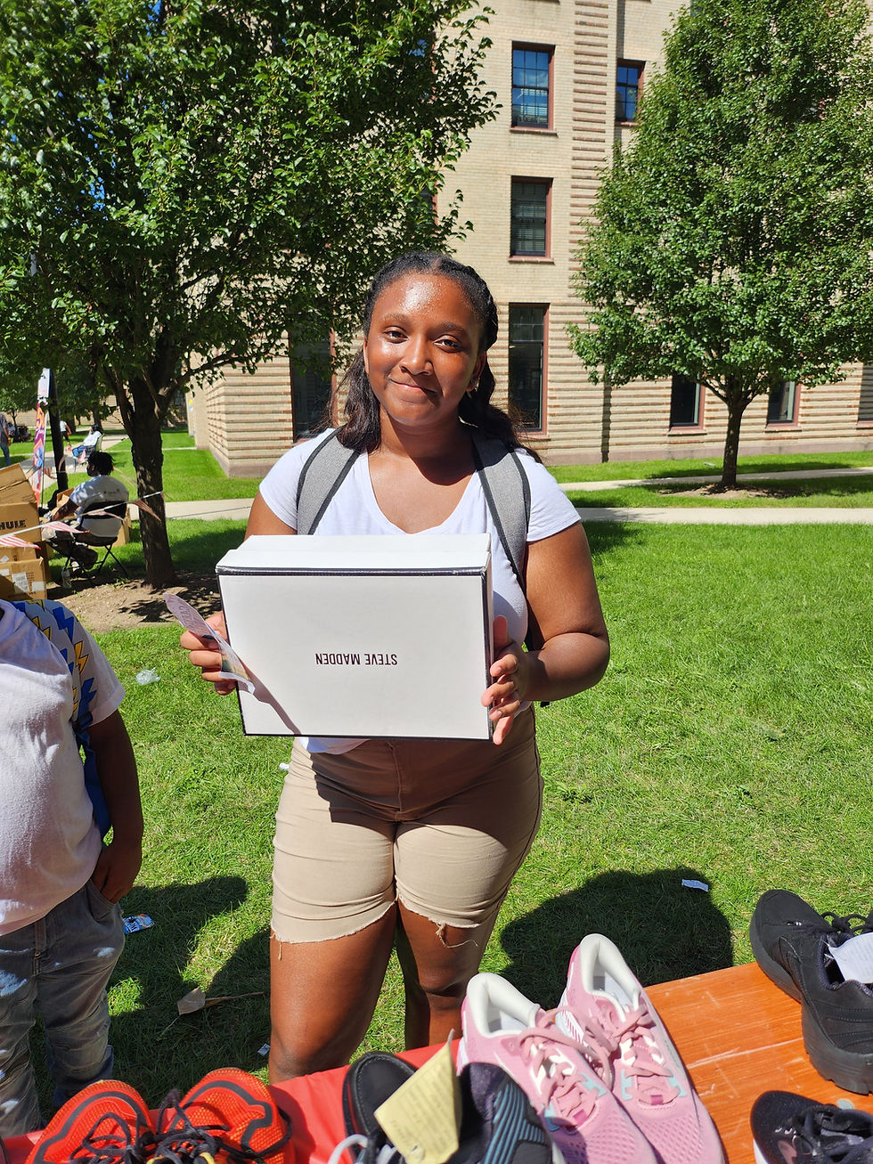 Woman holding a white box at a shoe donation event