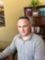 Steven LaBrie seated in an office with bookshelves, LICSW and Clinical Supervisor at Inspira Counseling Center