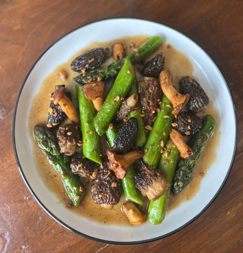 A sauté of Quebec asparagus, with morels, chanterelles, homemade oyster sauce, kampot pepper and fried garlic