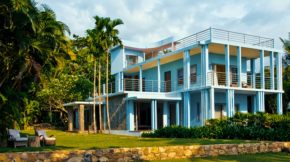 La villa bleue emblématique, posée entre pelouse et cocoteraie