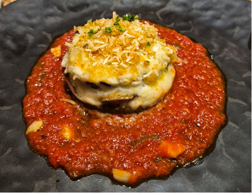 Aubergine parmigiana — eggplant baked with tomato and cheese, from the house menu
